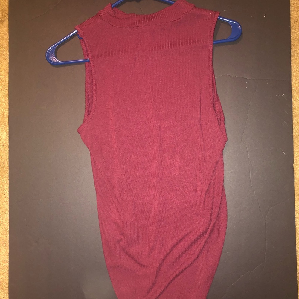 A burgundy body suit